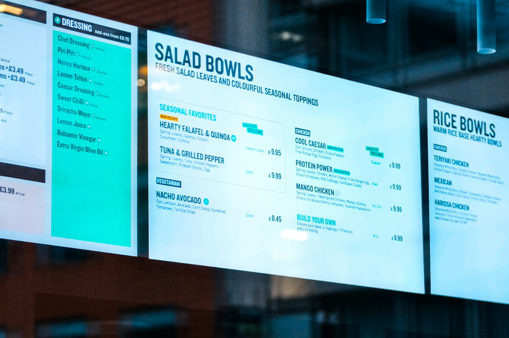 Menu board displaying options for salad and rice bowls. Sections include dressings, seasonal favorites, and chicken dishes. Modern and appetizing design.