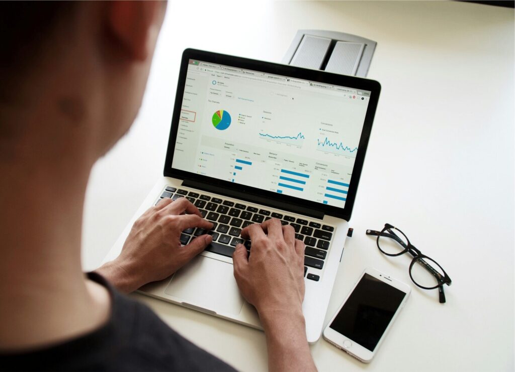 A man analysing SEO performance and Google Business statistics on a laptop screen, representing digital marketing insights and business growth tracking.
