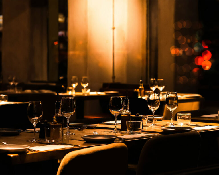 A fully set dining table inside a restaurant, creating a welcoming and ready-to-serve dining environment.