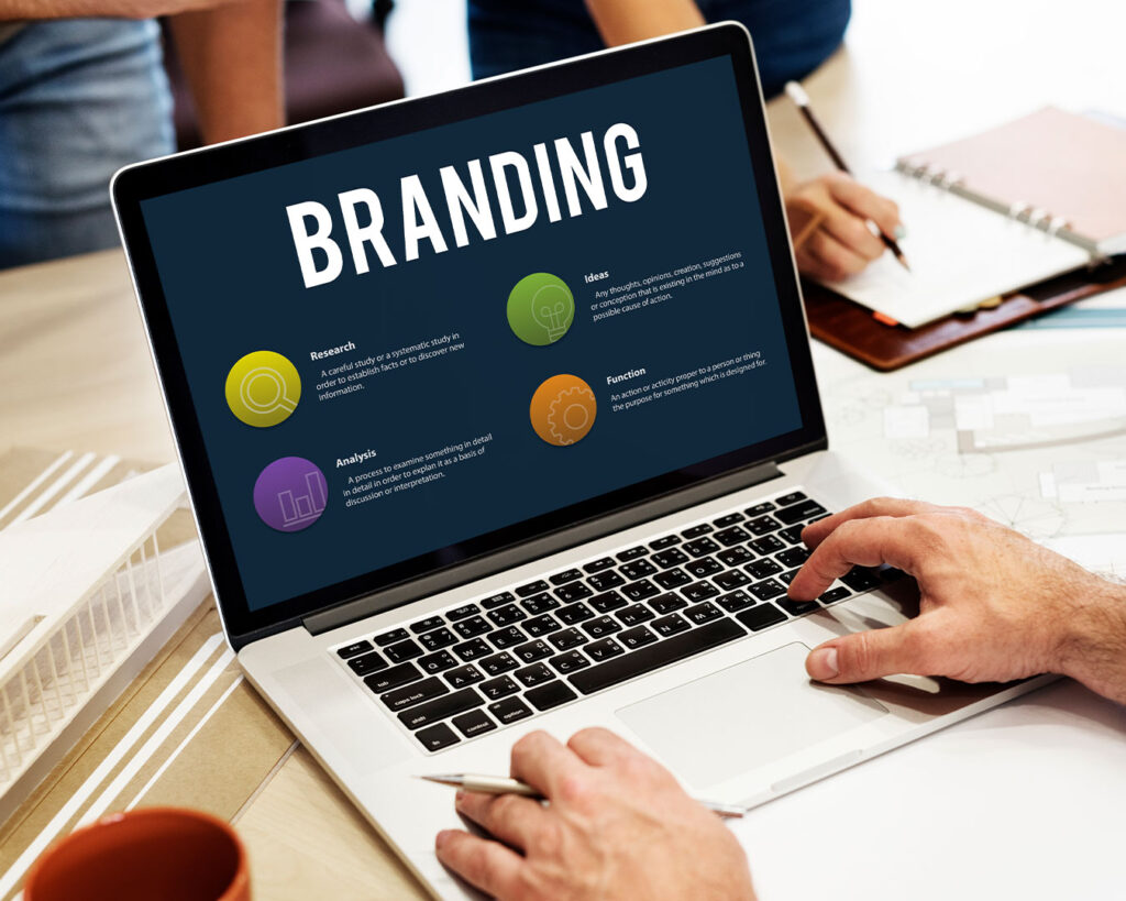 A laptop screen presents creative branding ideas for a restaurant, including menu concepts, visual mood boards, and design elements for marketing materials.