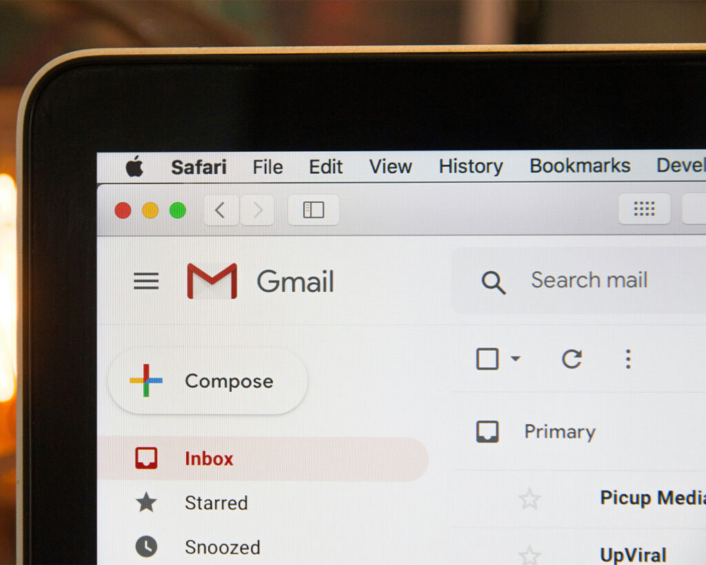A laptop screen showing an open Gmail inbox with incoming messages, representing customer enquiries, reservations, and business communications in progress.