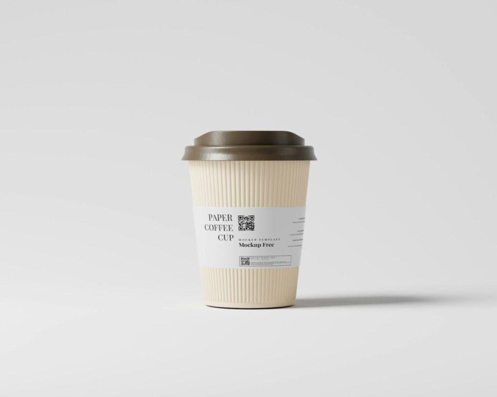 A beige paper coffee cup with a brown lid and a white label stands upright against a plain light gray background.