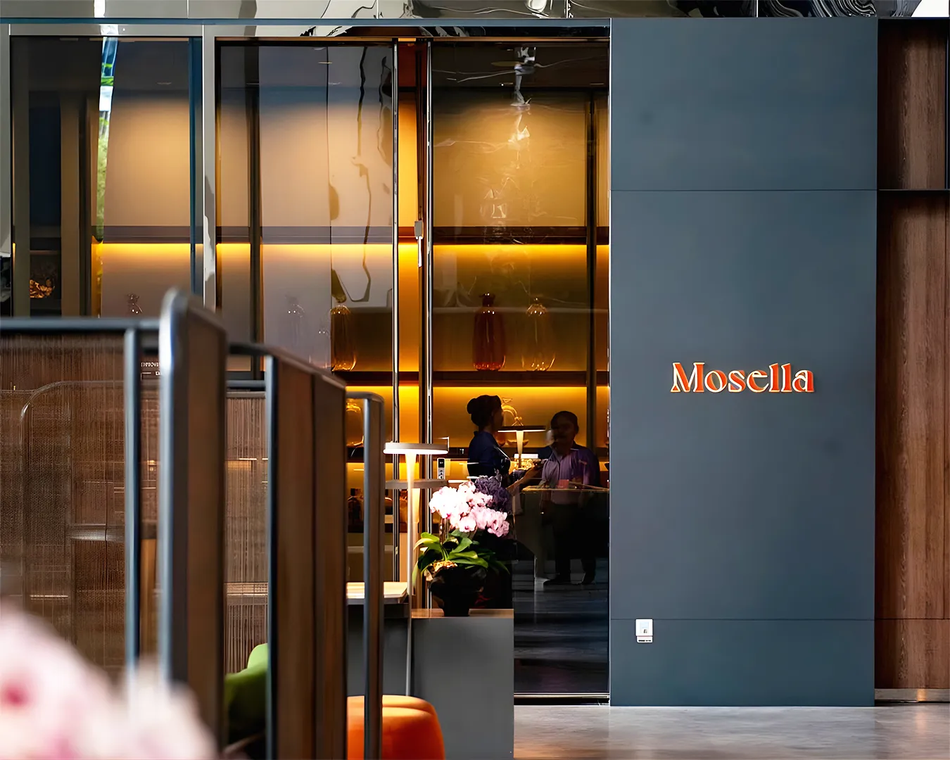 Modern restaurant entrance in Singapore with refined signage and warm lighting, reflecting strong brand identity and first impression