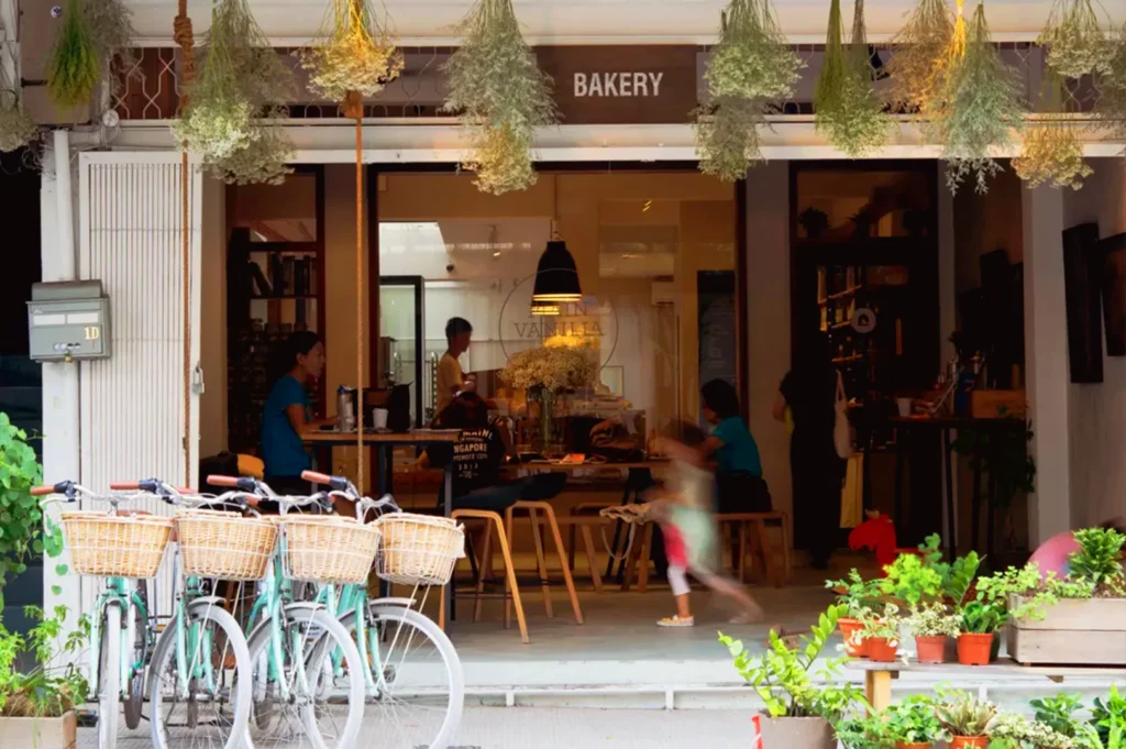 Neighborhood bakery café in Singapore with outdoor seating and bicycles, representing hyperlocal restaurant marketing and community presence