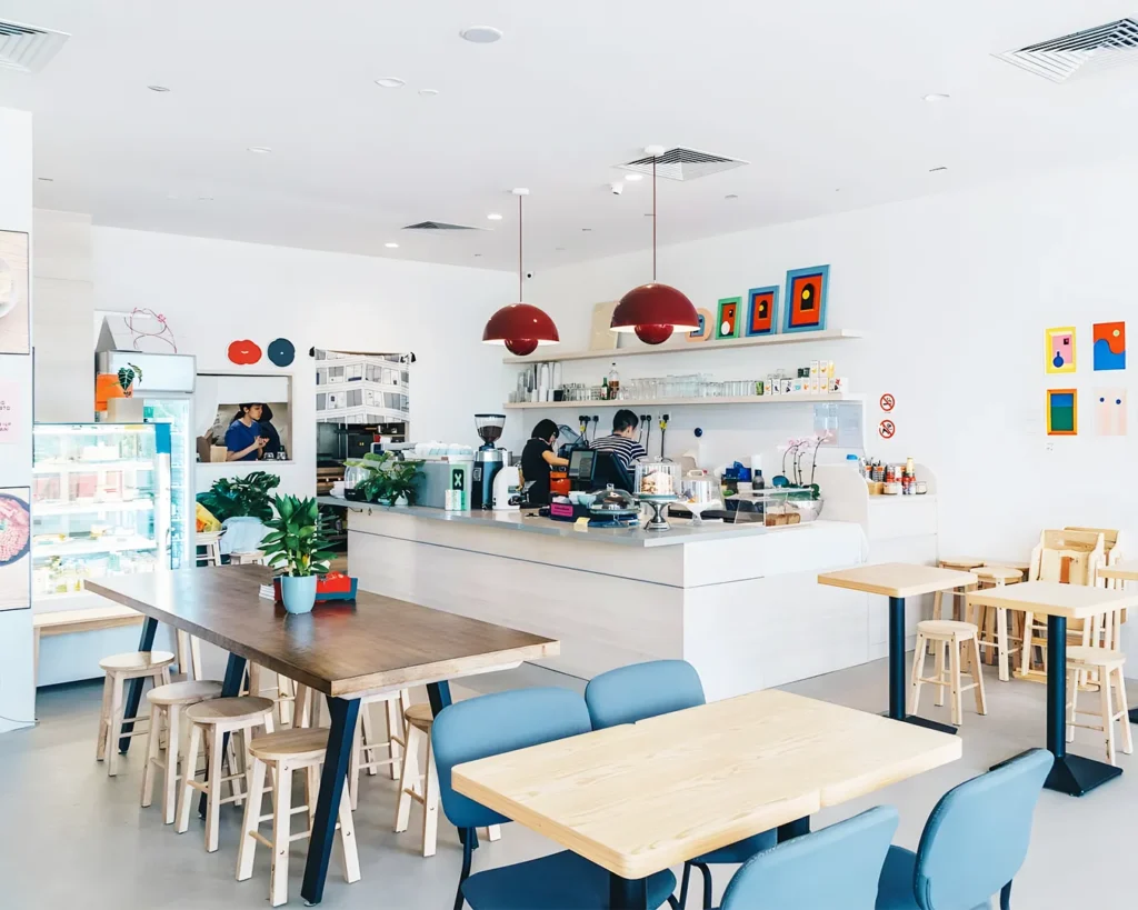 Café interior in Singapore with clean layout and consistent design elements, showing cohesive branding for new restaurant concepts