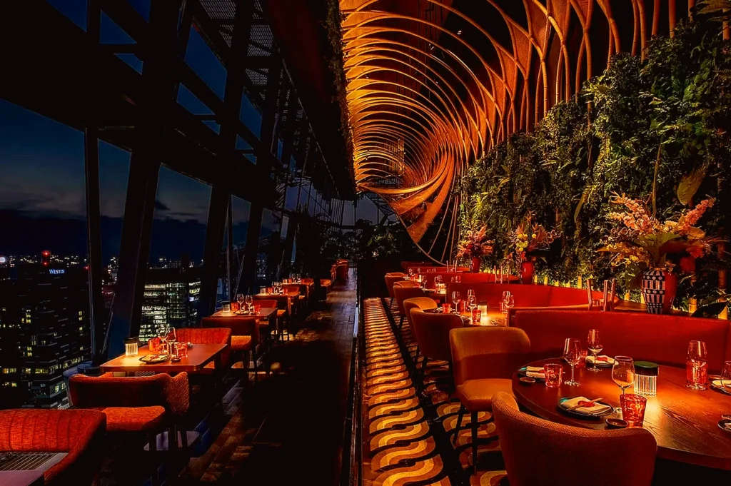Upscale rooftop restaurant in Singapore with ambient lighting and skyline views, representing strong branding and premium dining experience