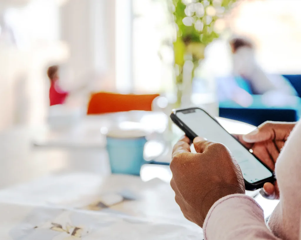 Person scrolling restaurant menu on mobile phone in Singapore, demonstrating mobile-first design for dining decisions