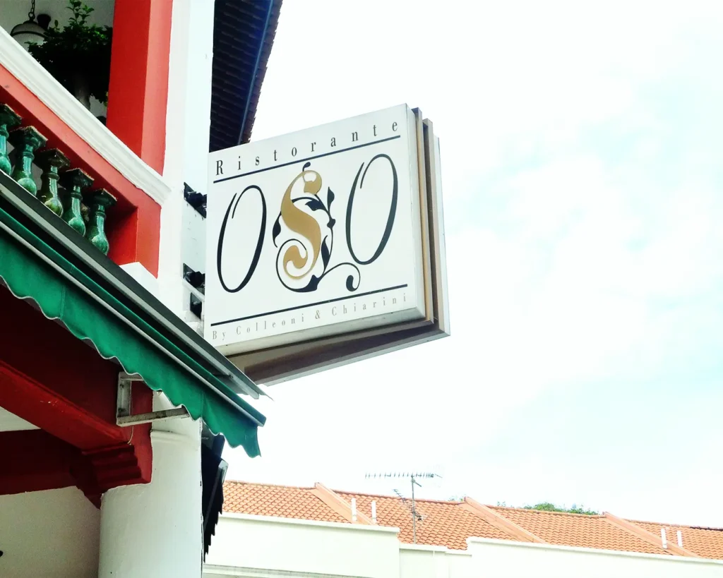 Restaurant signboard in Singapore with clear logo and typography, highlighting visibility and readability from street level