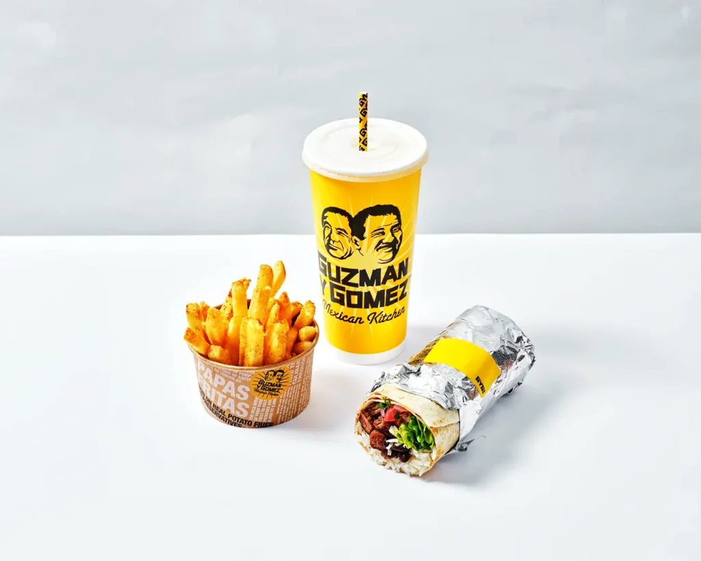Restaurant packaging in Singapore with consistent logo design across cup, fries box, and wrap, reinforcing strong brand identity