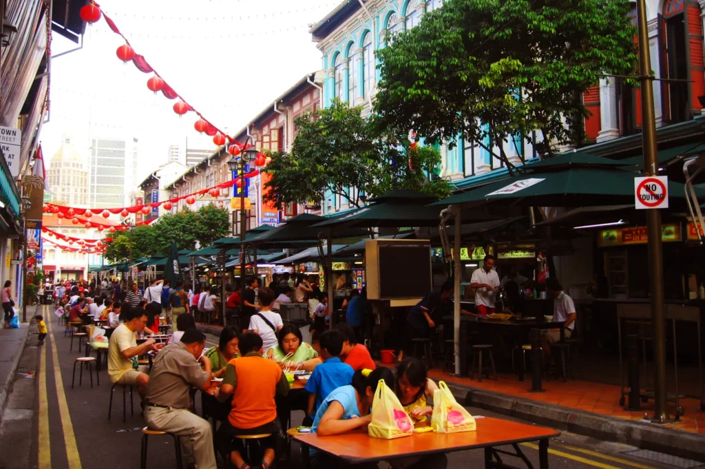Busy outdoor dining street in Singapore with multiple restaurants and diners, illustrating competitive F&B environment and need for strong branding