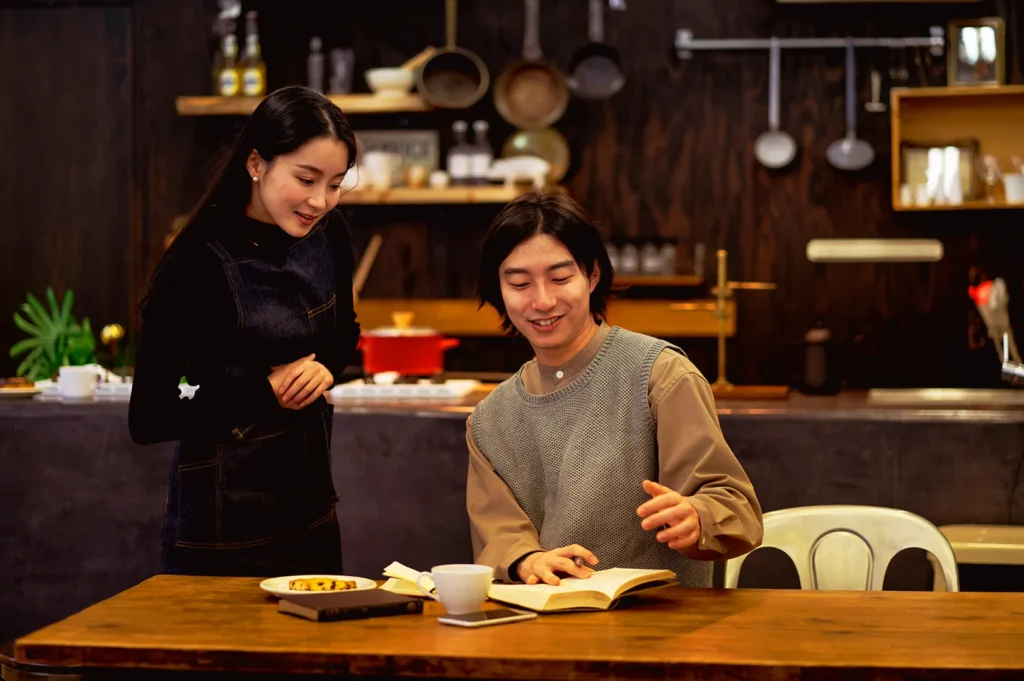 Restaurant staff interacting with a guest in Singapore, reflecting customer engagement and long-term brand loyalty in F&B