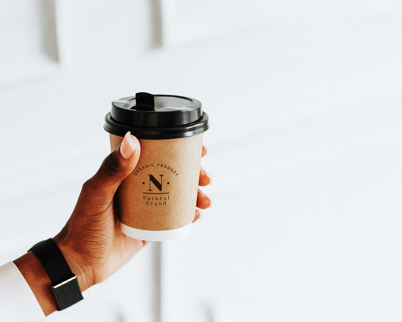 Minimalist takeaway coffee cup with clean logo design, representing strong restaurant brand identity and consistent visual branding