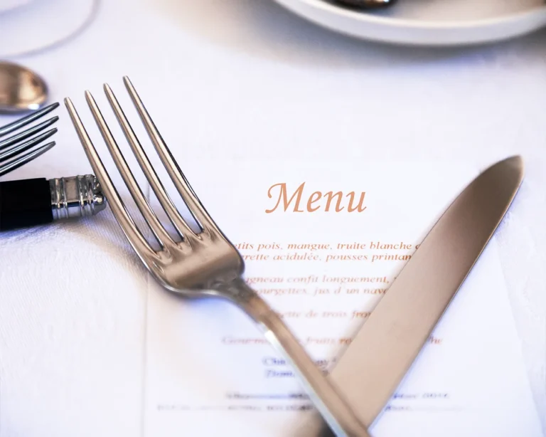 Elegant fine dining restaurant menu with polished cutlery and minimalist table setting, showcasing premium menu design for modern restaurant branding