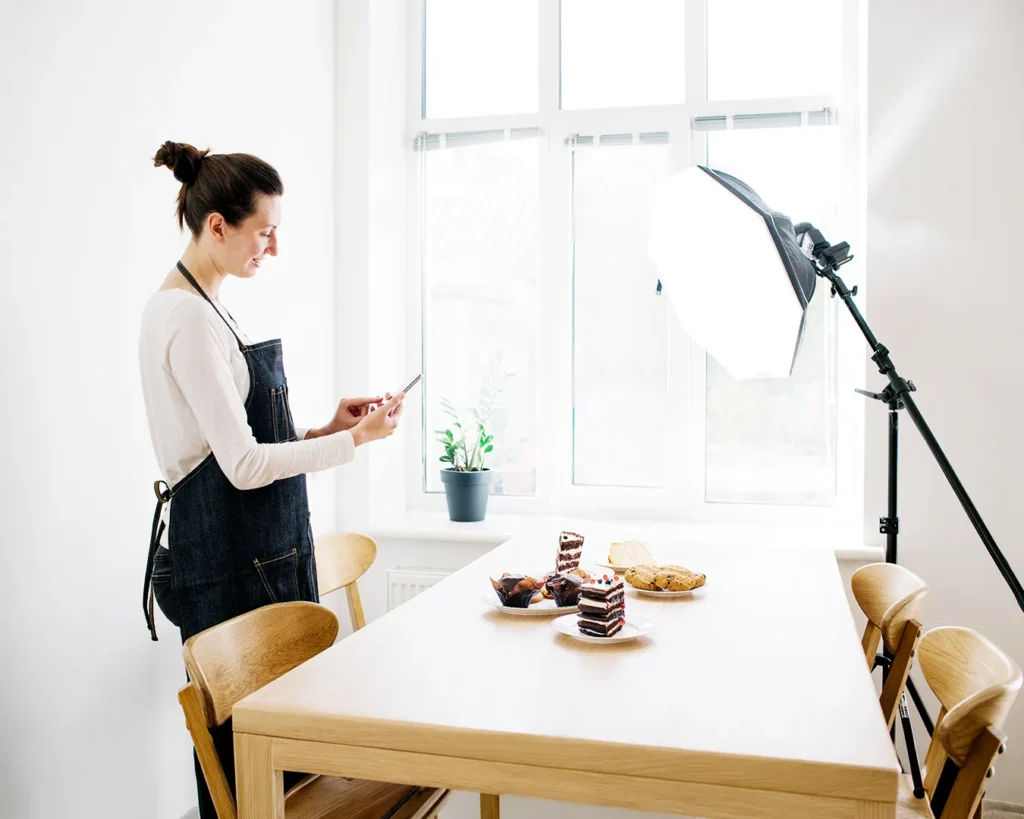 Restaurant owner photographing pastries for authentic social media content creation and food branding