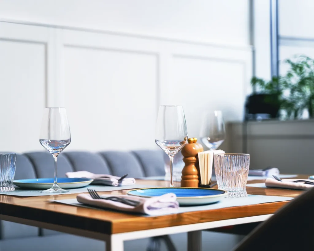 Elegant minimalist restaurant table setting with refined dining presentation, representing strong brand clarity and consistent hospitality experience