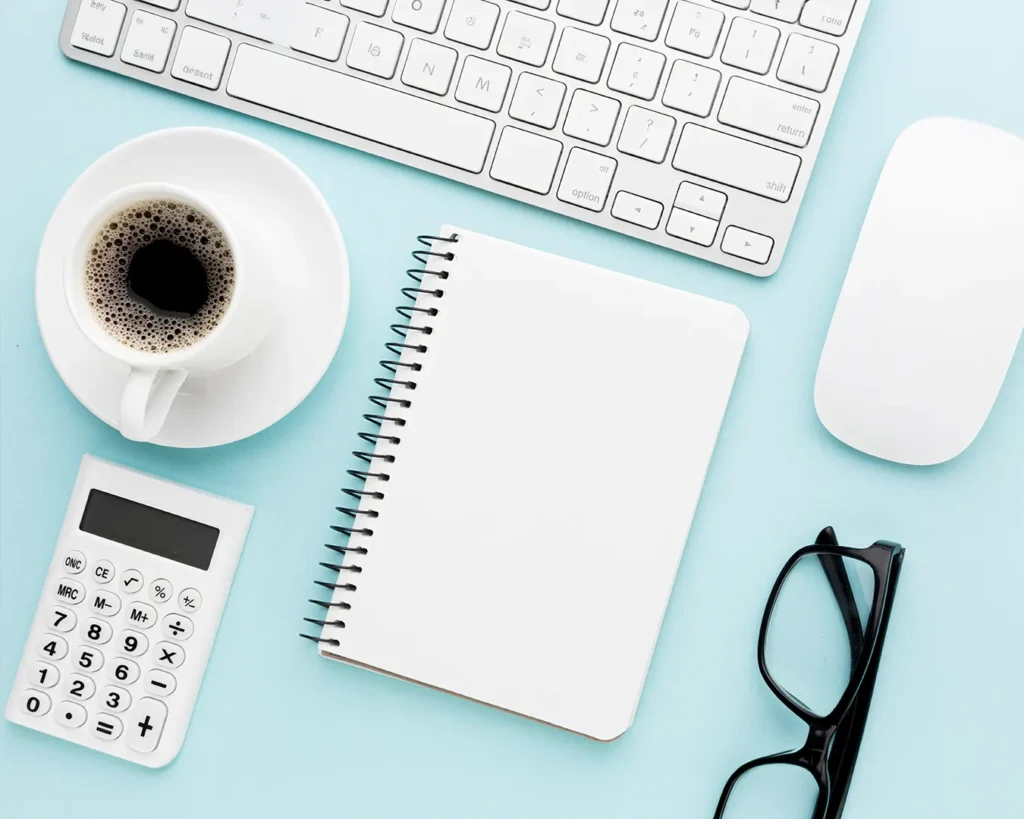 Restaurant branding cost planning Singapore with calculator notebook coffee and business budgeting workspace flat lay