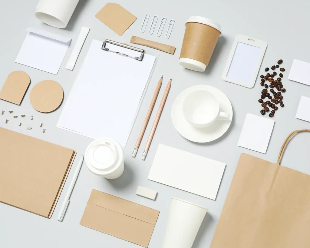 Flat lay of minimalist restaurant branding stationery, coffee accessories, packaging materials, and cafe identity essentials for contemporary F&B rebrand
