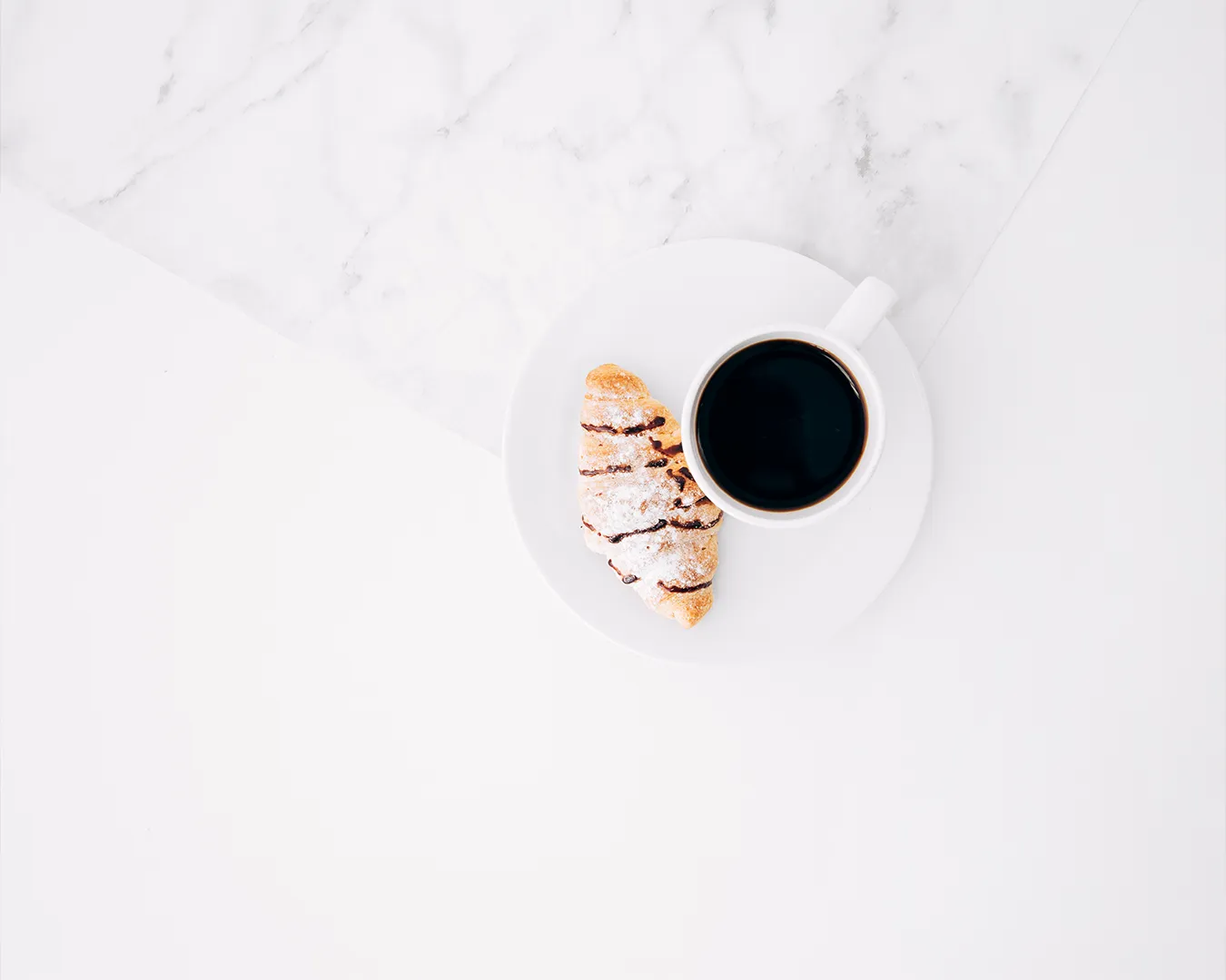 Minimalist coffee and pastry flat lay on white marble table, restaurant brand voice planning and hospitality marketing concept