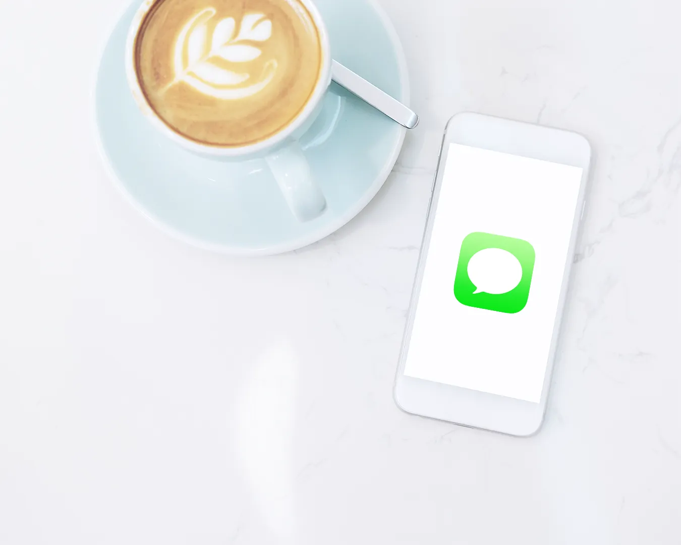 Restaurant SMS marketing flat lay with coffee and smartphone on marble table