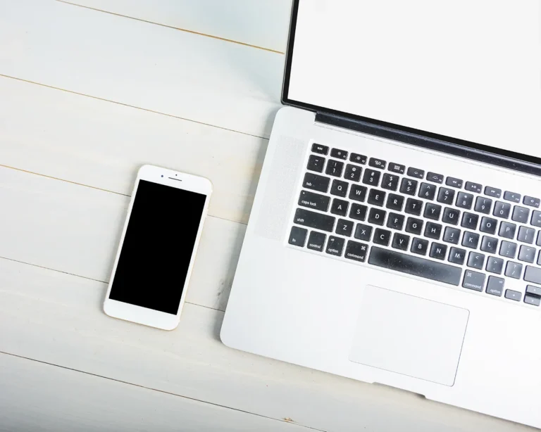 Restaurant website and Instagram marketing audit workspace with laptop and smartphone on a clean desk for restaurant digital branding and social media consistency.
