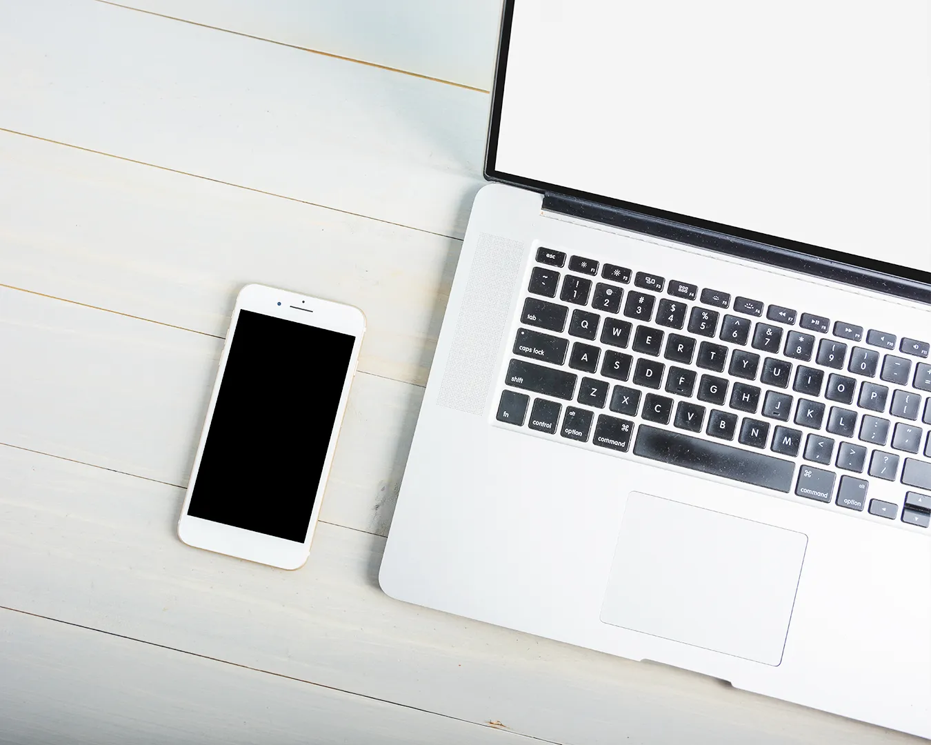 Restaurant website and Instagram marketing audit workspace with laptop and smartphone on a clean desk for restaurant digital branding and social media consistency.