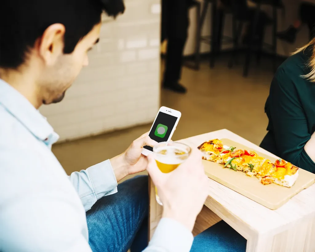 Restaurant loyalty SMS campaign viewed on smartphone during casual dining experience