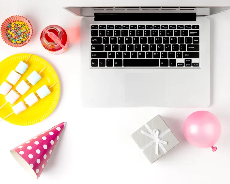 Automated birthday email marketing workspace with laptop and party decorations, representing restaurant customer engagement and birthday campaign automation.