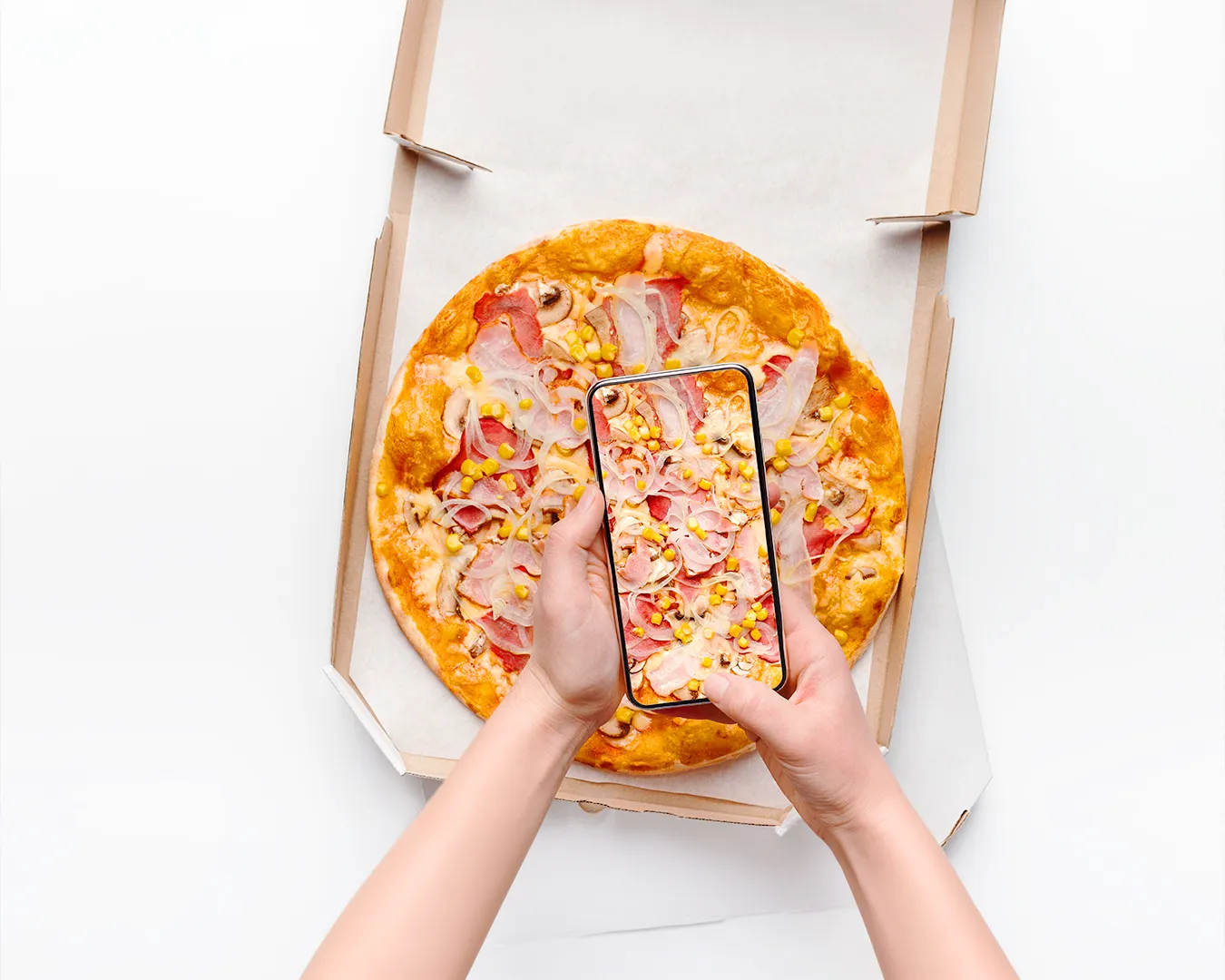 Customer photographing pizza in takeaway box for food delivery app menu listing and restaurant delivery marketing