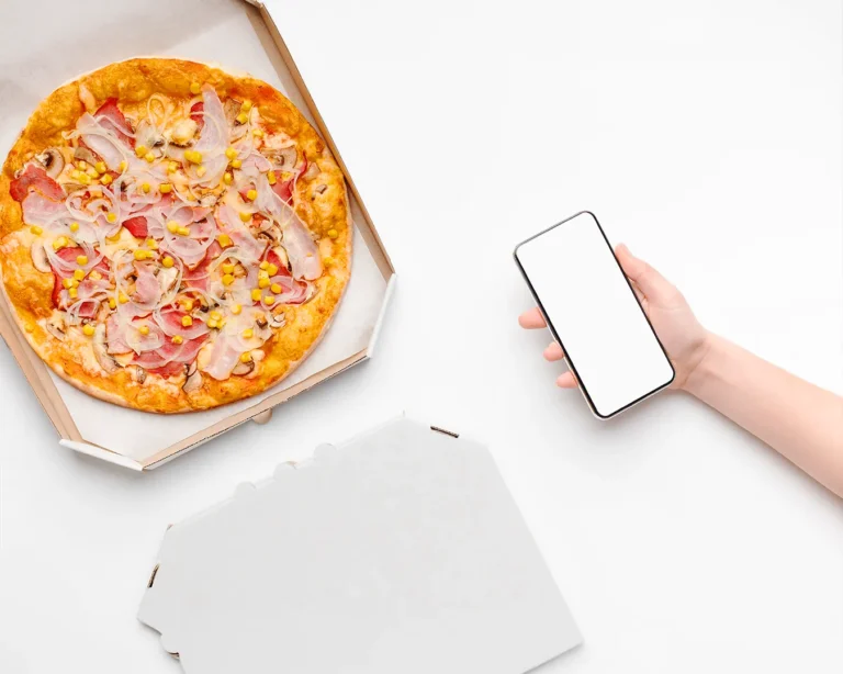 Customer ordering pizza online with smartphone, illustrating web-based restaurant loyalty program and mobile food ordering.