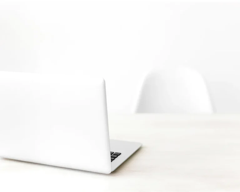 Minimalist restaurant business workspace with laptop on clean desk, representing automated restaurant marketing and digital operations.