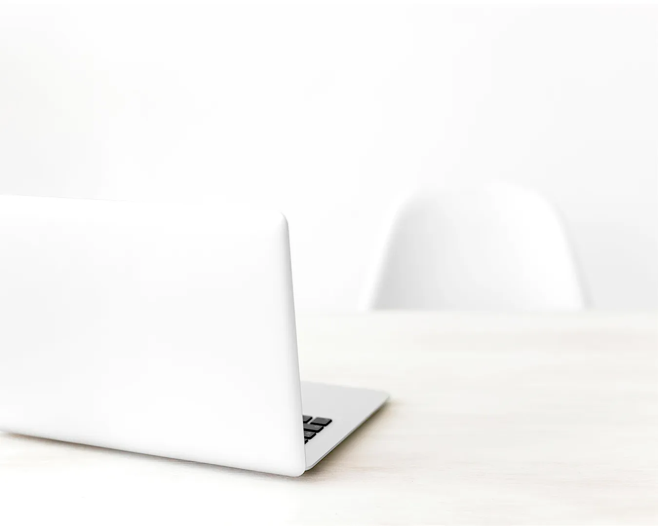 Minimalist restaurant business workspace with laptop on clean desk, representing automated restaurant marketing and digital operations.