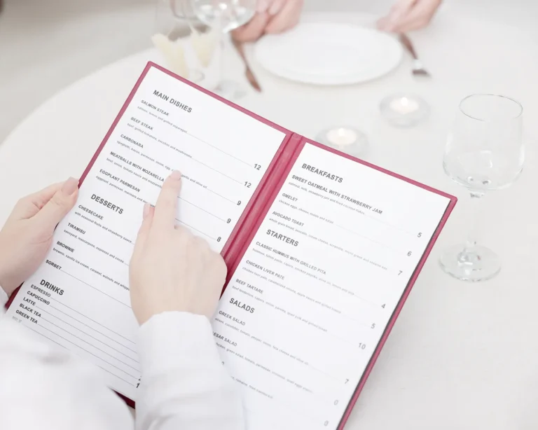 Guest reading a professionally designed restaurant menu, showcasing clear typography, menu layout, and premium restaurant branding.