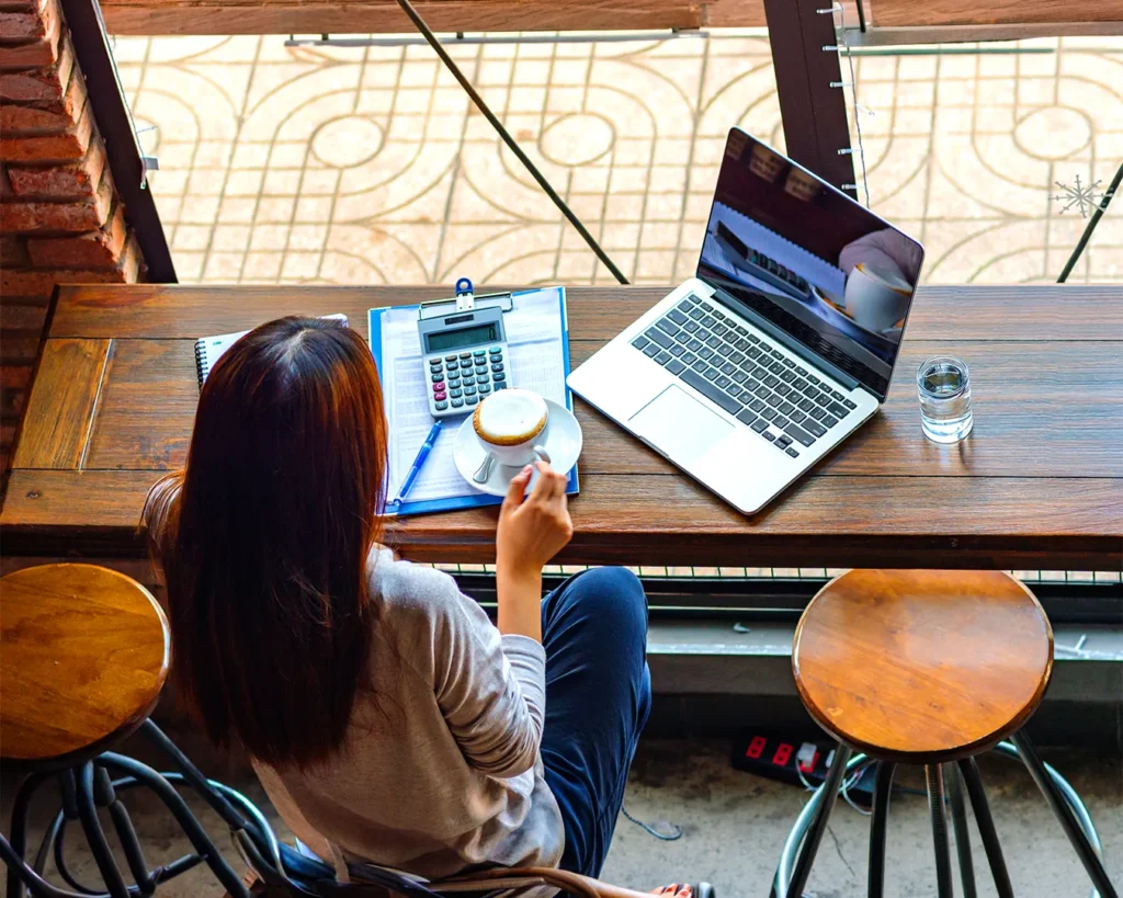 Restaurant owner reviewing customer retention data and reservation analytics on laptop