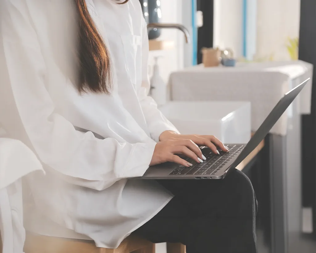 Restaurant owner managing automated birthday email campaigns and customer database on laptop in a modern hospitality workspace.