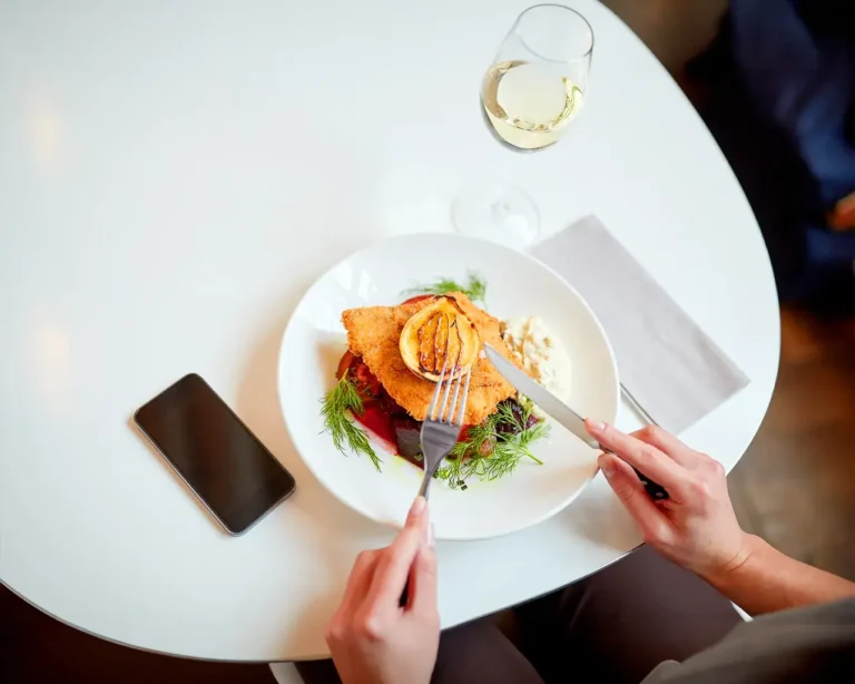 Restaurant diner using smartphone for loyalty rewards program at dining table