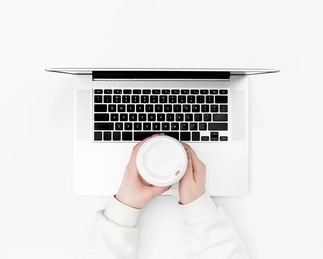 F&B email marketing automation workspace with laptop and takeaway coffee on minimalist white desk