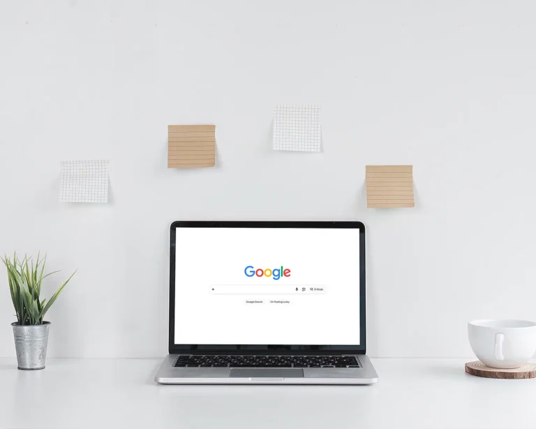 Minimal laptop displaying Google search on a clean white workspace, representing restaurant SEO, Google Business Profile optimisation, local search visibility, and digital branding.