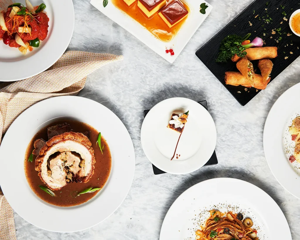 Overhead view of assorted restaurant dishes and plated food for menu analysis and menu engineering