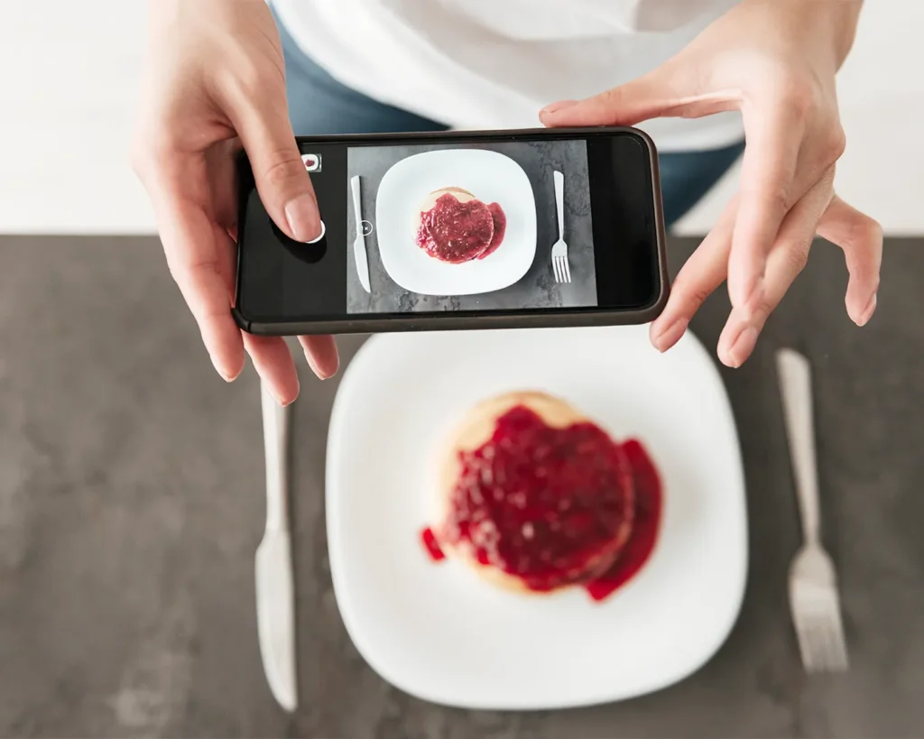 Food influencer photographing dessert for social media content