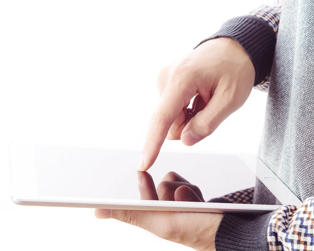 Hand using a tablet with a minimalist interface, illustrating restaurant website optimisation, mobile search experience, and digital customer journey.