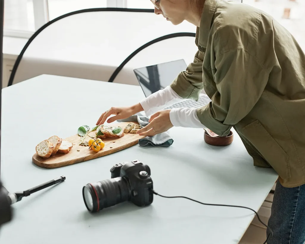 Food content creator styling a dish for professional restaurant photography