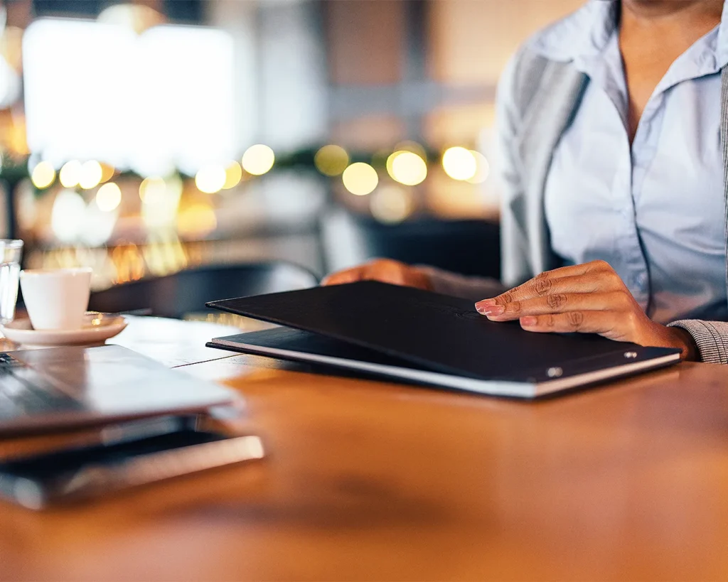 Restaurant owner reviewing digital branding and online presence with a menu folder, symbolizing restaurant SEO strategy, Google Business Profile management, and hospitality marketing.