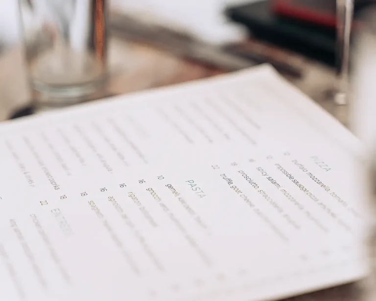 Restaurant menu featuring gourmet dishes and prices for menu psychology and customer spending