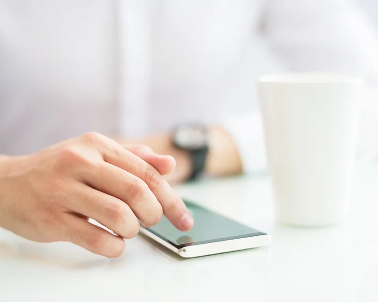 Customer using smartphone for restaurant communication, representing email and SMS marketing for repeat diners