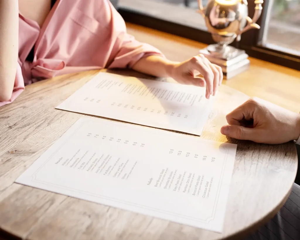 Customer reviewing restaurant menu and placing a direct food order at a table