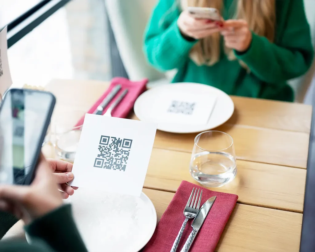 Customer scanning QR code menu for restaurant table ordering with smartphone
