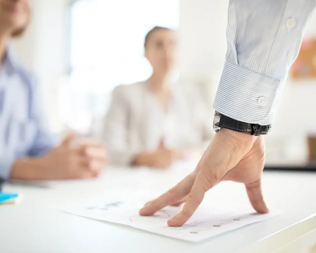 Business team reviewing documents and discussing marketing strategy during a professional meeting