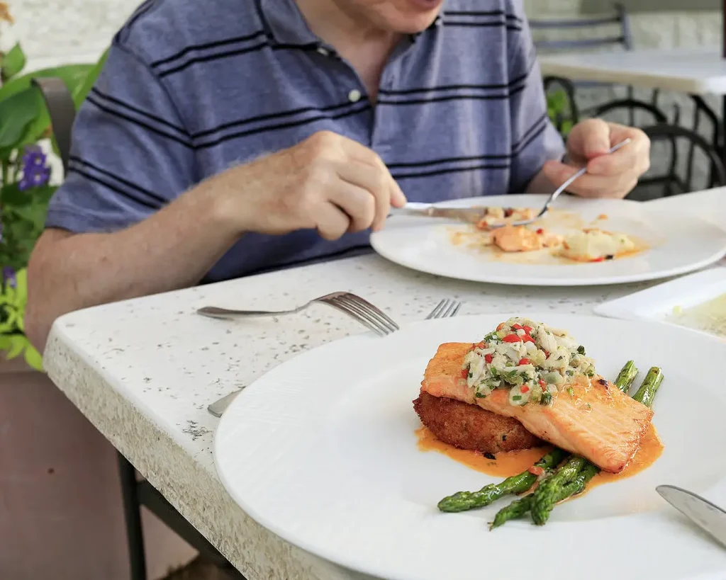 Customer enjoying a well-presented restaurant meal, highlighting consistency and neighbourhood dining loyalty