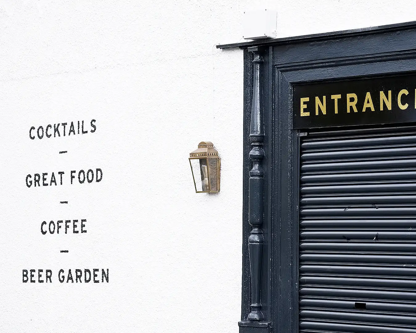Restaurant entrance signage with custom typography and branded lettering for restaurant identity