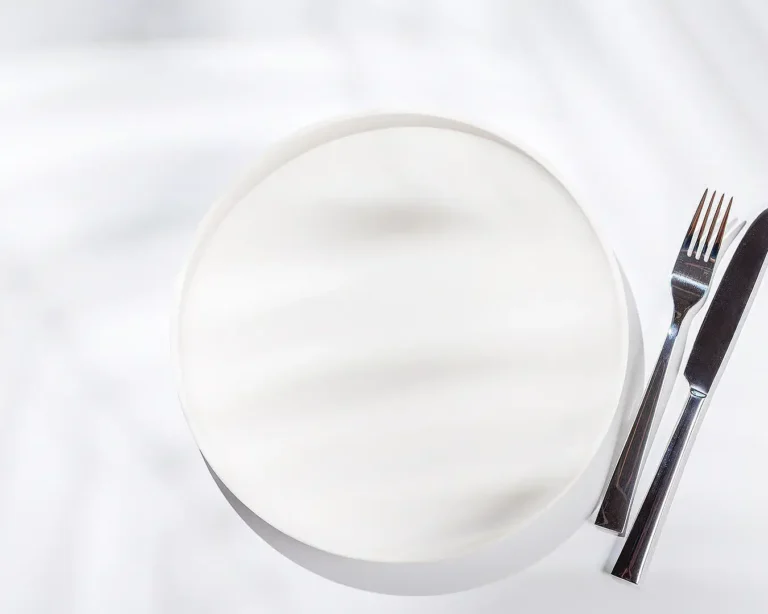 Chef plating an elegant dish, representing restaurant food presentation and menu branding